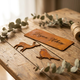 Personalised Corten steel gift pieces arranged on a timber table