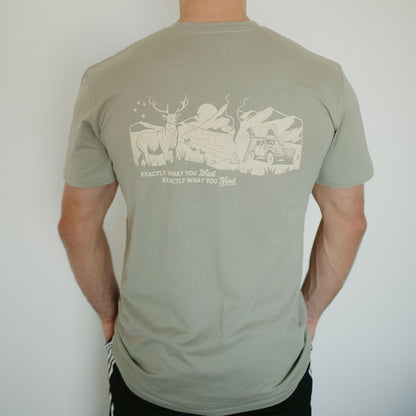 Man wearing a green t-shirt with a graphic design on the back against a white background