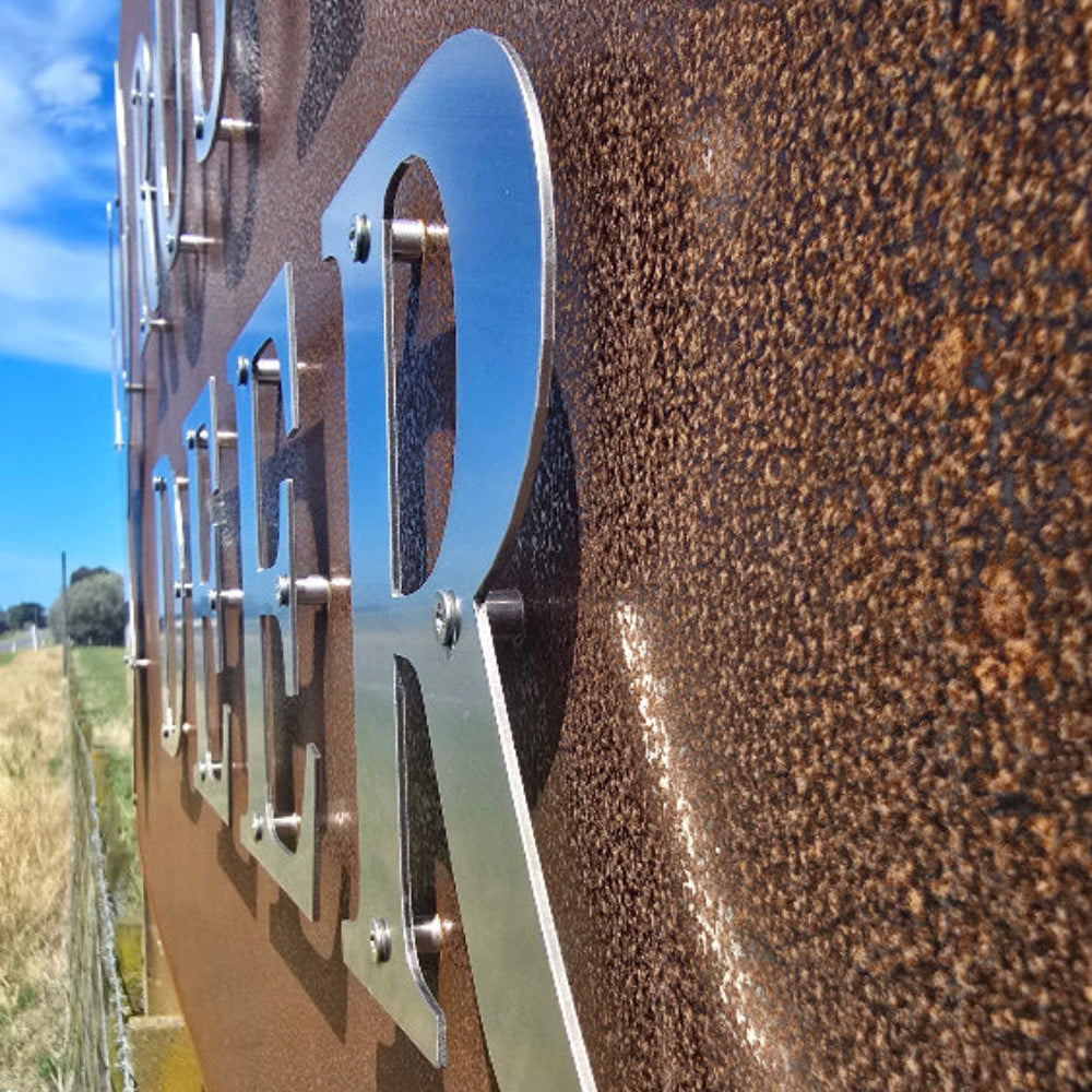Metallic object on a textured brown surface with a blurred natural background