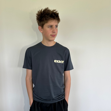 Person wearing a black 'exacq' t-shirt and black Nike shorts against a plain background