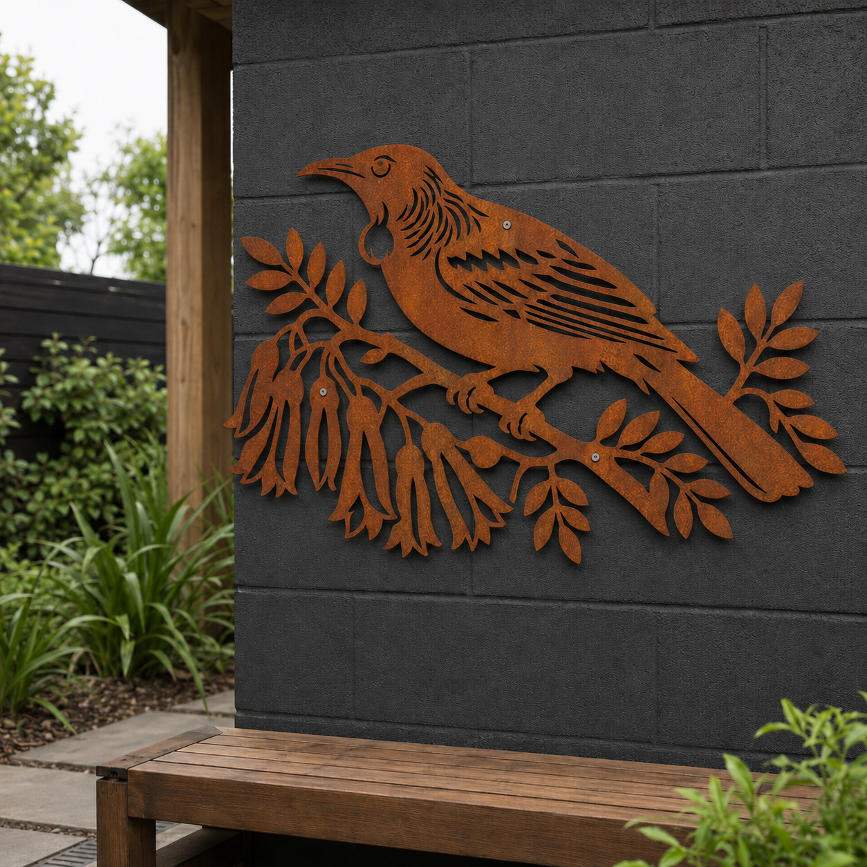 Corten steel Tui Bird wall art in a New Zealand garden setting